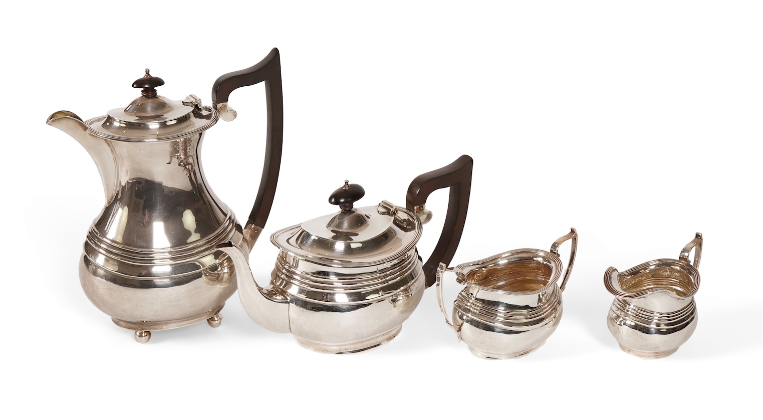A George V four piece silver tea set, comprising teapot, hot water pot, sugar bowl and milk jug, by S. Blanckensee & Son Ltd